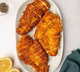 crispy chicken caesar salad, In a gray oval platter the crispy is sliced and placed