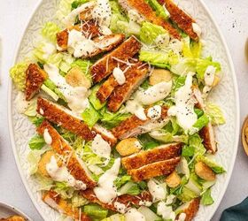 crispy chicken caesar salad, Crispy Chicken caesar salad served over a oval platter and garnished with grated parmesan cheese