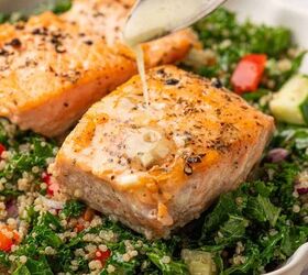 salmon kale quinoa salad, Lemon Dijon dressing drizzle on a salmon kale quinoa salad
