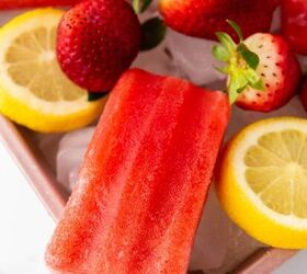 healthy homemade strawberry popsicles recipe, Strawberry popsicles with cut lemons on a tray