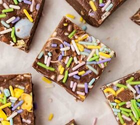 easter fudge, Top view of colorful chocolate squares on a white surface sprinkled with pastel rainbow sprinkles Each piece appears to be a rich chocolate treat studded with additional colorful candies or cereal pieces