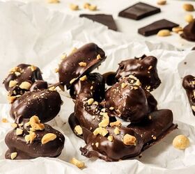 peanut butter stuffed dates, Chocolate covered stuffed dates on parchment paper and stacked on top of each other