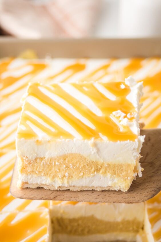caramel cheesecake bars, A slice of caramel cheesecake bars on a wooden spatula