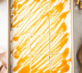 caramel cheesecake bars, Cool Whip and caramel sauce on top of the bars and sliced