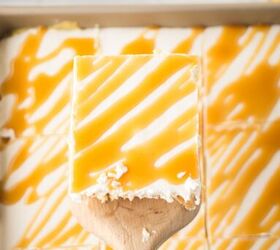 caramel cheesecake bars, A slice of caramel cheesecake bars on a wooden spatula