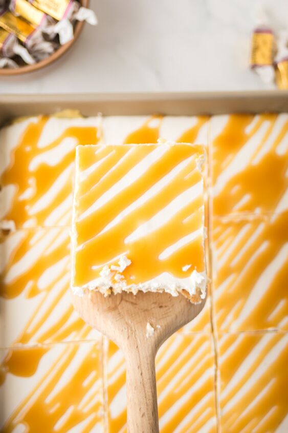 caramel cheesecake bars, A slice of caramel cheesecake bars on a wooden spatula
