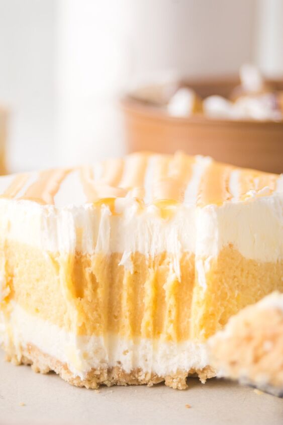 caramel cheesecake bars, A slice of caramel cheesecake bars with a piece bitten off