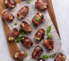 prosciutto wrapped dates, Dates sitting on a wooden cutting board