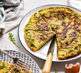 spanish zucchini tortilla, Zucchini tortilla de patatas on a plate next to a plate with a slice and salad on it