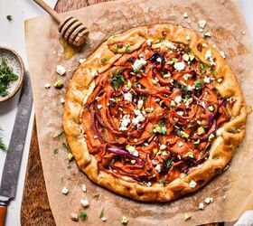 spicy carrot feta galette, Overhead shot of spicy carrot and feta galette on a piece of parchment next to a honey dipper