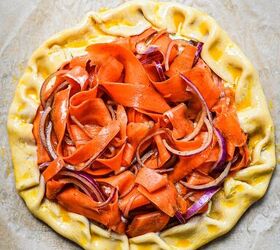 spicy carrot feta galette, Edges of the pie crust folded in towards the filling to create a galette shape before baking