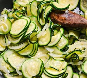 spanish zucchini tortilla, Sliced zucchini cooking in the skillet with the onions
