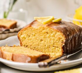 lemon loaf cake, Lemon loaf cake on a plate with a slice off the end and fresh lemon on the top