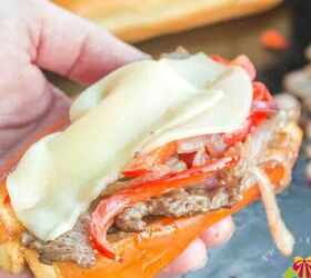 smashed potatoes with cheese, Holding the Philly cheesesteak hot and fresh right above the griddle It has melted provolone grilled onions and peppers and a hot dog bun grilled to perfection
