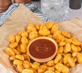 air fryer gnocchi, Crispy air fried gnocchi resting in parchment paper in a serving bowl Marina sauce in the middle to dip in