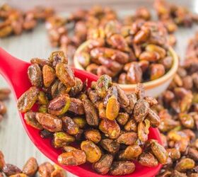 honey roasted pecans in air fryer, red saddle filled with pistachios and more pistachios in background