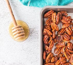 honey roasted pecans in air fryer, pecans on cookie sheet and honey dipper on table