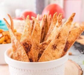 air fryer cinnamon tortilla chips and apple pie dip, tortilla triangle chips in white bowl Apple dip out of focus back and apples in basket