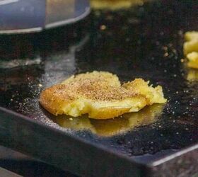 smashed potatoes with cheese, Baby Dutch Yellow Potatoes on the griddle with seasoning sprinkled on top