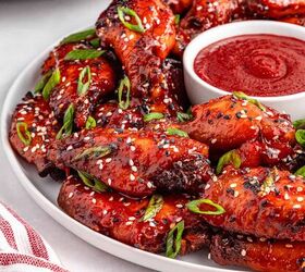 easy slow cooker korean chicken wings recipe, Crispy Korean chicken wings topped with sesame seeds and green onions served on a plate