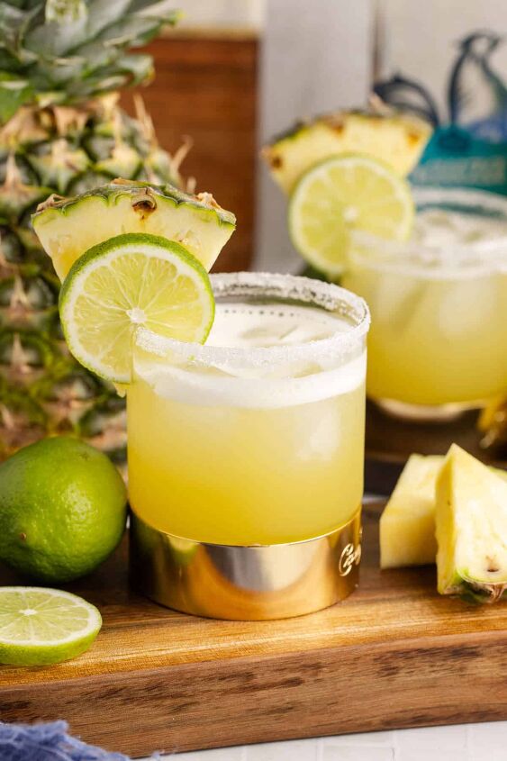 pineapple margarita, Pineapple Margarita with Pineapple and Lime Garnish on a Cutting Board
