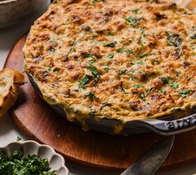 cajun crab spinach artichoke dip, Cajun crab spinach artichoke dip served in a cast iron skillet wit melted cheese on top