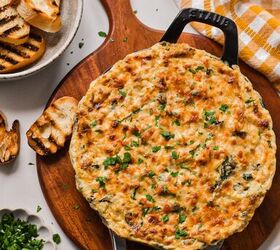 cajun crab spinach artichoke dip, Cajun spinach artichoke dip in a cast iron skillet topped with a layer of melted cheese