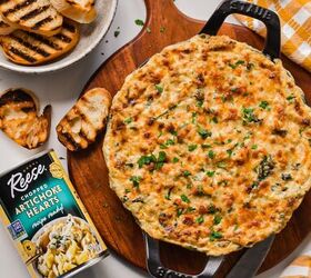 cajun crab spinach artichoke dip, Overhead shot of Cajun spinach artichoke dip in a cast iron pan on a wooden board