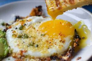 These parmesan chili crisp fried eggs are a little spicy, a little cheesy, and oh so crunchy