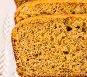 cake mix banana bread, Close up of sliced cake mix banana bread on a white rectangular plate The bread has a golden brown crust and a soft moist interior with visible banana speckles showcasing its fluffy texture
