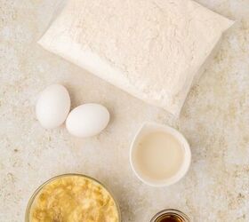 cake mix banana bread, Ingredients for cake mix banana bread a bag of cake mix two eggs a small bowl of mashed bananas a cup of milk and a small dish of vanilla extract on a light textured surface