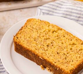 cake mix banana bread, A slice of cake mix banana bread on a white plate set on a striped cloth A whole banana and more sliced bread are visible in the background all on a light colored surface