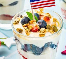 high protein banana split yogurt recipe for breakfast, Close up of ricotta parfait layered with blueberries strawberries and granola with a mint garnish and a subtle patriotic background