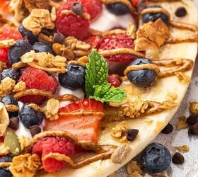 high protein banana split yogurt recipe for breakfast, Close up of fresh fruit and yogurt in a banana split garnished with cacao nibs and coconut flakes