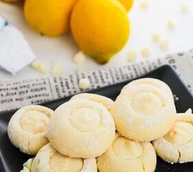 5 ingredient lemon white chocolate cookies with cake mix, A plate of lemon cookies displayed on a newspaper with lemons and chocolate chips nearby