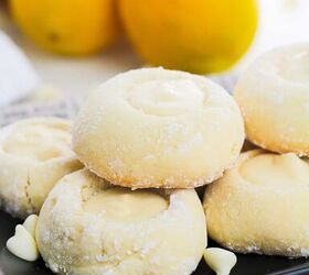 5 ingredient lemon white chocolate cookies with cake mix, A plate of lemon cookies displayed on a newspaper with lemons nearby closer view