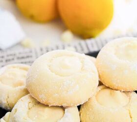 5 ingredient lemon white chocolate cookies with cake mix, A plate of lemon cookies displayed on a newspaper with lemons nearby