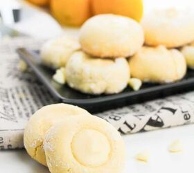 5 ingredient lemon white chocolate cookies with cake mix, A plate of lemon cookies displayed on a newspaper with lemons and white chocolate chips nearby
