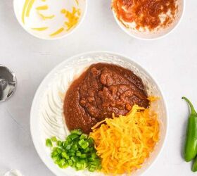 salsa and cream cheese dip, A bowl with cream cheese sour cream salsa shredded cheddar cheese and chopped jalape os ready to be mixed Nearby are bowls with leftover cheese and salsa a mixer with beaters and a fresh jalape o pepper