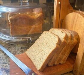 super soft milk bread recipe with fresh milled flour, slices of milk bread in front of the loaf stored in a glass cake dome