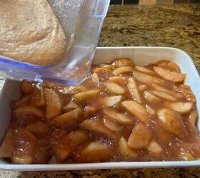 sourdough apple pie cobbler with fresh milled flour, pouring sourdough batter on top of apple pie filling in a baking pan