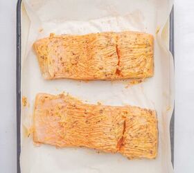 oven baked blackened salmon recipe, Two salmon fillets coated in butter and blackened seasoning in a baking dish