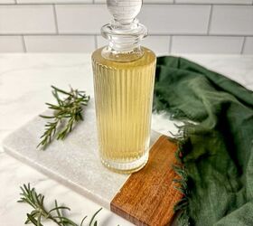rosemary simple syrup recipe with 3 ingredients, Rosemary simple syrup in a glass jar surrounded by fresh rosemary and a green kitchen towel