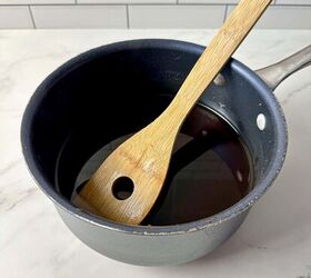 brown sugar simple syrup, A small saucepan containing simple syrup with brown sugar and a wooden spoon