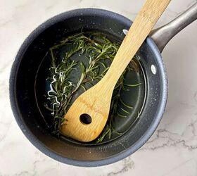 rosemary simple syrup recipe with 3 ingredients, Rosemary syrup in a saucepan with a wooden spoon