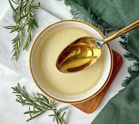 rosemary simple syrup recipe with 3 ingredients, Homemade rosemary simple syrup recipe in a bowl with a spoon