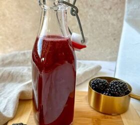 brown sugar simple syrup, Glass jar filled with a purple blackberry simple syrup surrounded by fresh blackberries