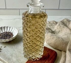 rosemary simple syrup recipe with 3 ingredients, Lavender simple syrup in a glass jar surrounded by dried lavender and a kitchen towel