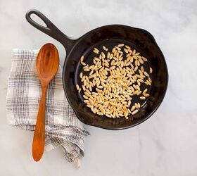 provencal tomatade, Toasted pine nuts in a cast iron skillet