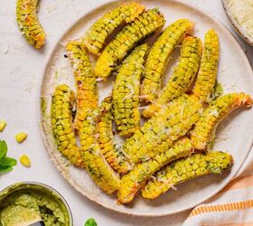 pesto butter corn ribs, Overhead shot of pesto butter corn ribs on a plate topped with parmesan cheese